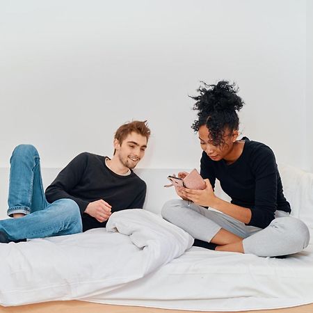 Mije Marais Hostel Párizs Kültér fotó A couple using their smartphones